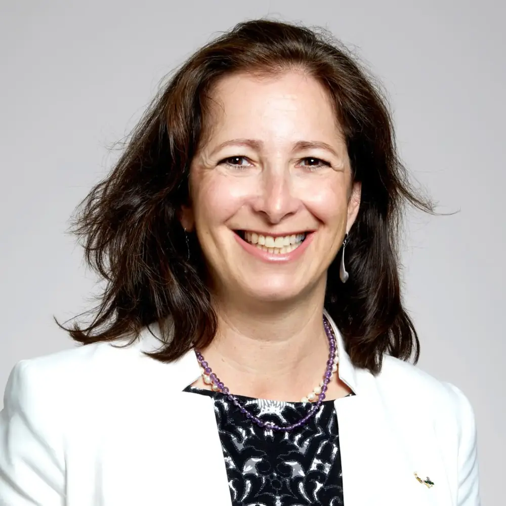 Molly Shoichet headshot, smiling in a white blazer