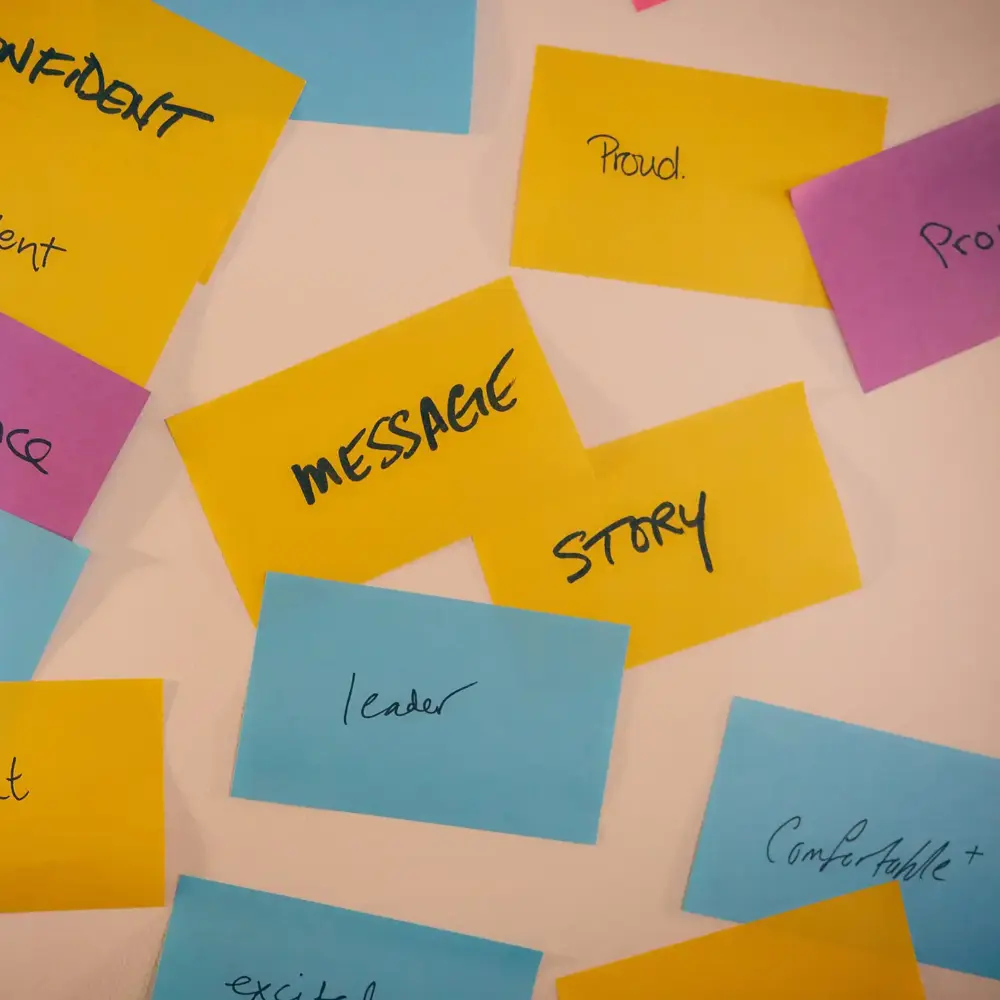 Colourful sticky notes reading confident, message, story, proud, and leader