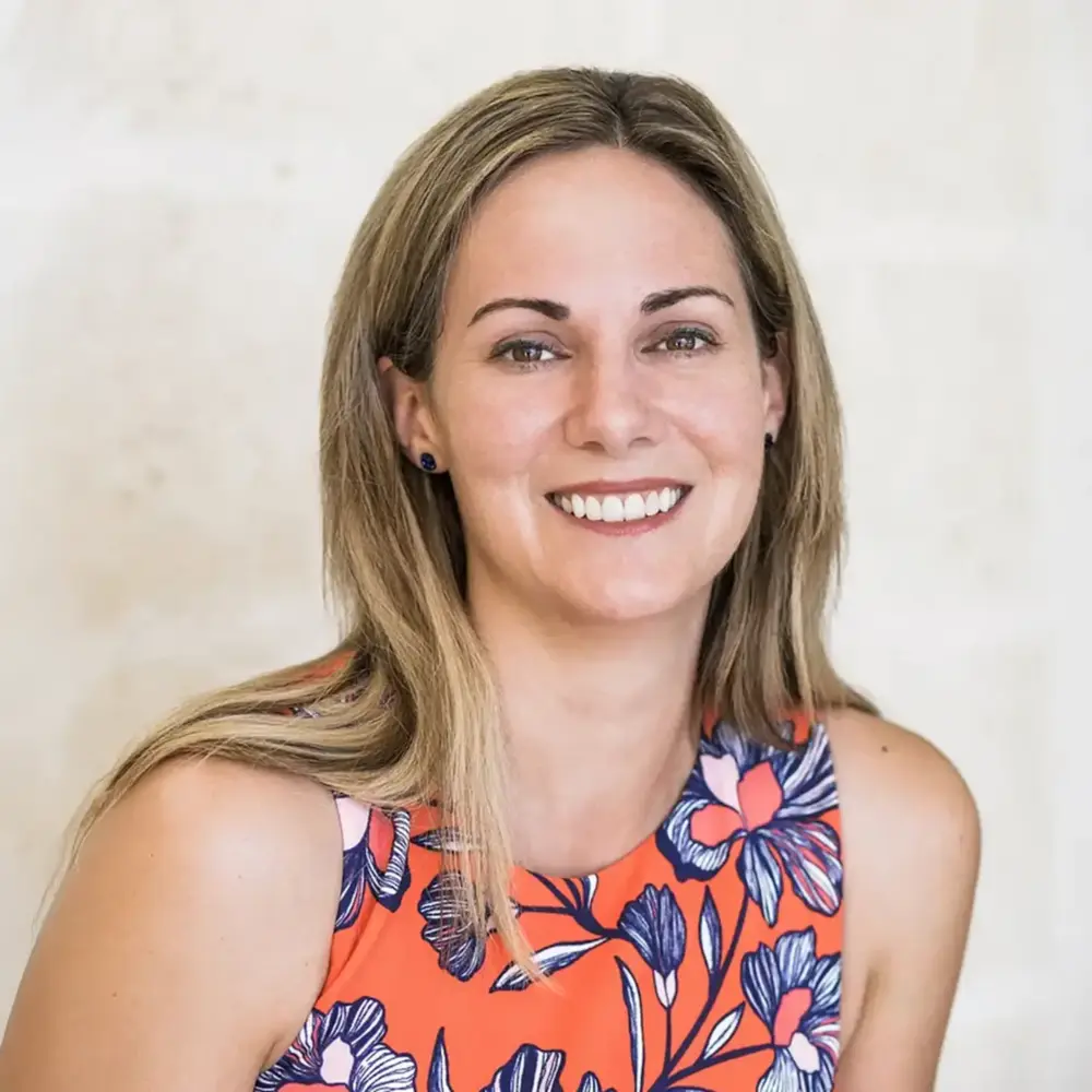 Susan Power headshot, smiling in a floral top
